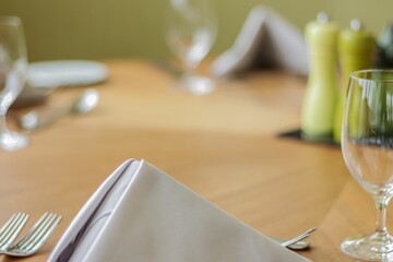 Selective focus of a white napkin on a restaurant dining table