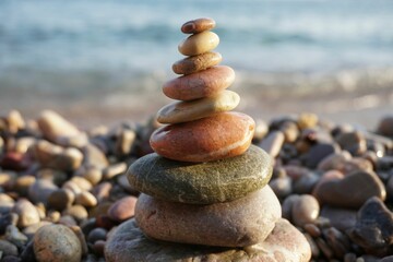 Close-up shot of cairn on the beach with the sea in the background