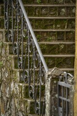 Vertical shot of a decorative handrail and stone stairs outdoors