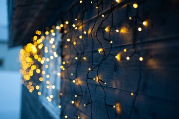 Closeup shot of a wooden house decorated with lighs
