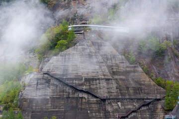 Metal steps leading vertically up the wall of a huge hydrolectric dam in Japan