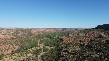 Aerial view of a canyon park with geological formations in Texas in blue sky background