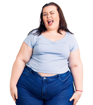 Young plus size woman wearing casual clothes winking looking at the camera with sexy expression, cheerful and happy face.