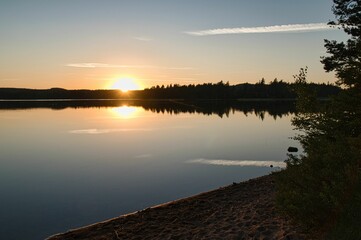 Beautiful bright sunrise over the lake shore