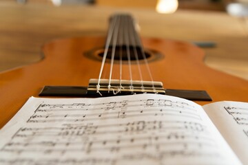 Fototapeta na wymiar Closeup of a music sheet on a guitar