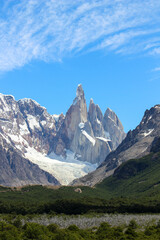 Vertical shot of the snowy Cerro Torre mountain surrounded with greenery in El Chalten, Argentina