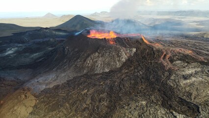 Fototapeta premium Landscape of erupting Mauna Loa Volcano in Hawaii with smoke and blue horizon sky