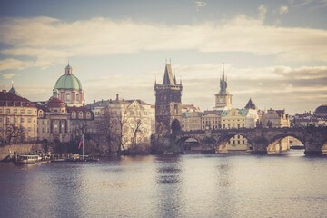 Scenic shot of the Charles Bridge with medieval architecture and a vintage filter in Prague, Czechia