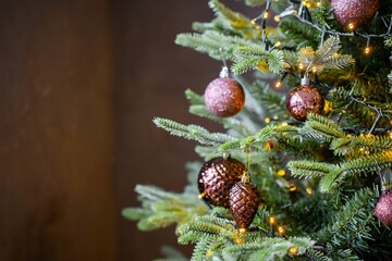 Closeup of a beautifully decorated Christmas tree with sparkly pink decorations and lights
