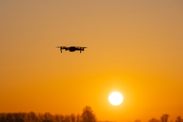 Drone flies towards an intense sunset through Sahara dust