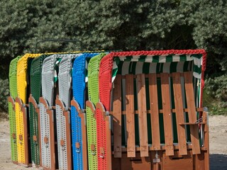 Fototapeta premium Colorful roofed wooden buildings on the beach in Germany.