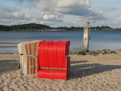 Beautiful shot of hooded beach chairs at the coast of Baltic sea in Eckernfoerde