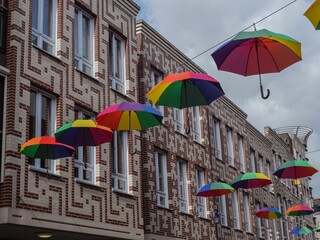 Low angle shot of colorful umbrellas hanging in the city