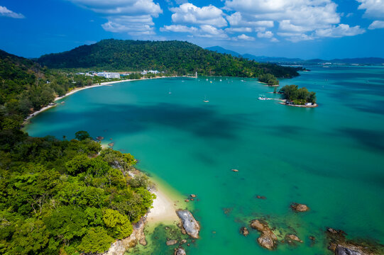 Blue ocean with a green shoreline and a mountain in the background, Pantai Kok, Langkawi,Malaysia