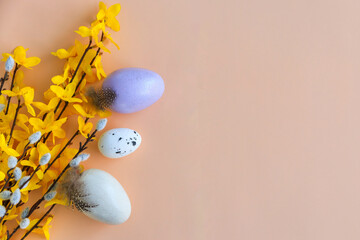 Composition of flowers, bunnies and Easter eggs on a pastel background