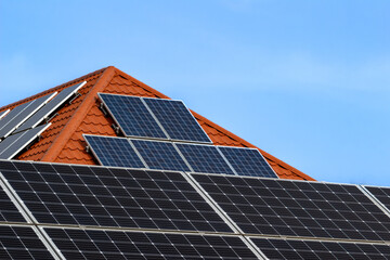 Fototapeta premium solar panel on modern tiled red roof