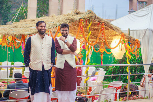 Indian man in traditional wear or kurta pyjama cloths. Male fashion model in sherwani, posing / standing against wedding mandap background