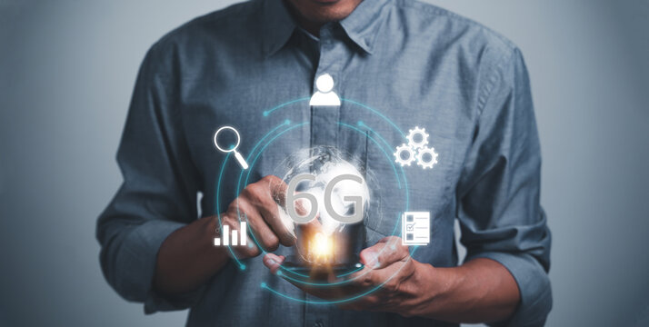 A man is holding a smartphone with a 6G Technology on it. Concept of communication technology and innovation of 5G and 6G