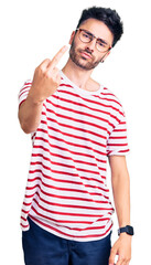 Young hispanic man wearing casual clothes showing middle finger, impolite and rude fuck off...