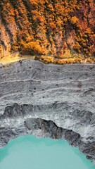 Ijen volcano at surnise seen from above in an artistic way, vegetation,crater and turquoise lake in Java, Indonesia