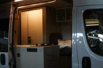 Interior design of a kitchen in a camper on wheels. Caravan, motorhome. Mobile home. Furniture