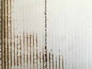 Old worn corrugated cardboard with a crack