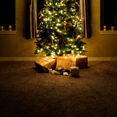 Christmas Tree in House Living Room With Wrapped Gifts at Night