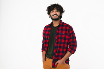 Happy Indian young man in casual clothes looking at camera isolated over white background. Cheerful...