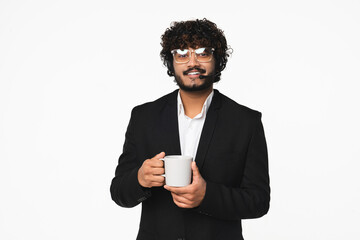 Cheerful young hotline support manager Hindu in headset drinking hot coffee isolated over white...