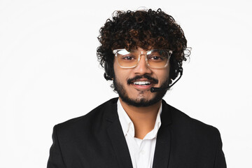 Young Indian dispatcher wearing headset with toothy smile isolated over white background. Hindu...