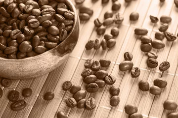 Zelfklevend Fotobehang Coffee grains in bamboo bowl. Morning breakfast. Grain for brewing. Coffee storage. © Evgenii