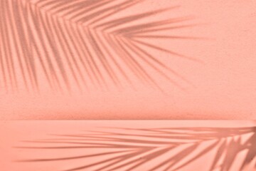 Minimal modern product display on Empty room wall background with tropical palm leaves shadow overlay, top view. Moukup for Spring and summer