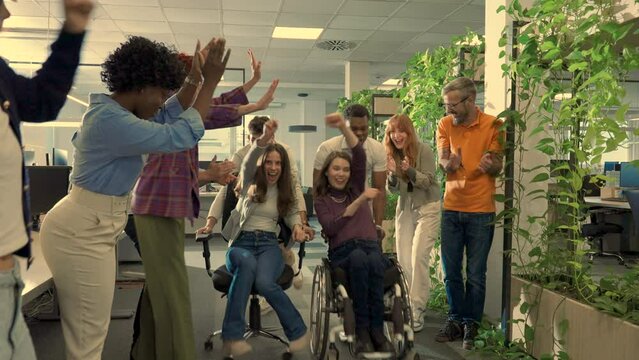 Portrait of a diverse inclusive people having fun and racing on office chairs