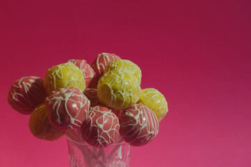 candy on a stick, cake pops, sweet cake in colored glaze. dessert. background for the design