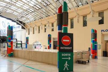 Reception and signage using color codes in the entrance hall of hospital.