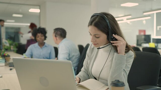 A telemarketing service worker is having a call with customer.
