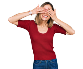 Young blonde girl wearing casual clothes covering eyes with hands smiling cheerful and funny. blind concept.