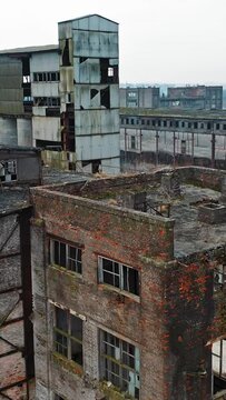 Ruins of an old factory. Old industrial complex. Aerial view Vertical video