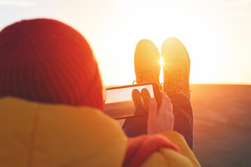 A woman in an yellow jacket relaxing alone on the top of mountain  at sunrise or sunset on spring...