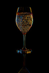 White Wine Glasse with sparkling water over Black Background. - 775082256