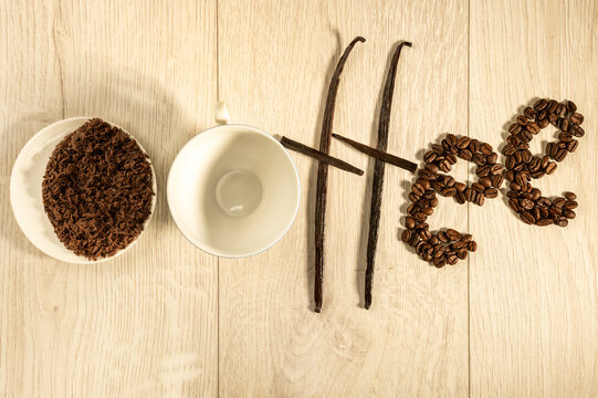 The inscription "coffee" of the coffee beans, cup, vanilla and grated chocolate.