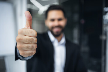 businessman worker showing thumb up selective focus. Manager man boss male company recommend sign approval gesture agree - 775083644