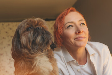 woman having fun and relaxing time at home with the shih tzu dog. Free and happy time at home...