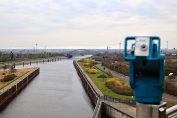View over canals near Magdeburg with coin-operated binoculars in blurred foreground - 775086612