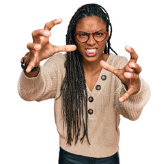 African american woman wearing casual clothes shouting frustrated with rage, hands trying to...