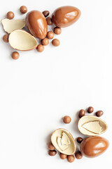 Chocolates background with chocolate eggs and sweets, top view