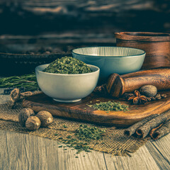 CHIVE FLAKES on wooden table background. Herbs, spices and dried food baking ingredient. Mortar and...