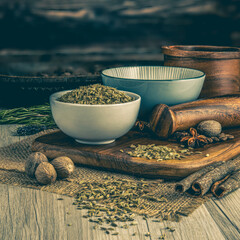 Fennel Seeds on wooden table background. Herbs, spices and dried food baking ingredient. Mortar and...