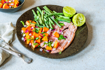 Pan fried gammon with papaya salsa and green beans