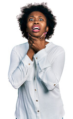 African american woman with afro hair wearing casual white t shirt shouting and suffocate because painful strangle. health problem. asphyxiate and suicide concept.